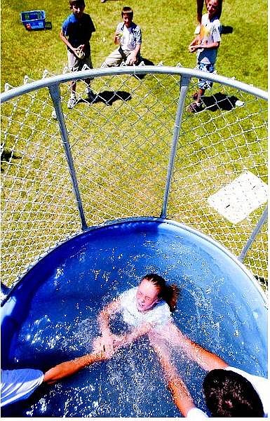 BRAD HORN/Nevada Appeal Jasmine Miller, 7, of Carson City  receives a hand after getting dunked at Ross Gold Park in Carson City during National KidsDay on Sunday afternoon.