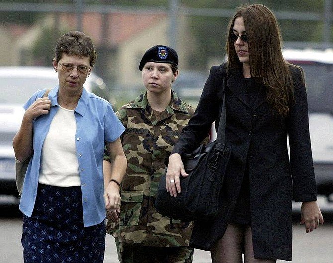 Pfc. Lynndie England, center, arrives at a military court at Fort Bragg, N.C., Tuesday, Aug. 3, 2004 for the beginning of her article 32 hearing, with  two unidentified women. She faces up to 38 years in prison if convicted of all charges.  England is the soldier accused of abusing Iraqi prisoners and creating lewd photos. (AP Photo/Chuck Burton)