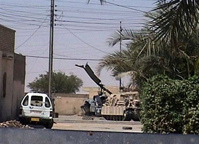 A U.S. Marine helicopter is grounded in Najaf Iraq, after being shot down during fighting in the southern Iraqi city in this image taken from TV Thursday Aug. 5, 2004. A U.S. military spokesman said no one was killed in the incident. (AP Photo/APTN)  ** TV OUT  **