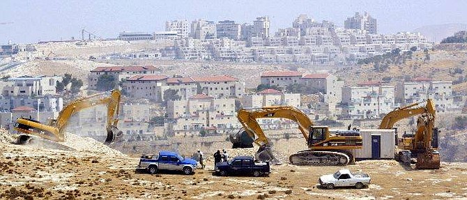 Israeli bulldozers prepare the ground for the construction of a West Bank road Thursday, Aug. 5, 2004, on a hill in the outskirts of the Jewish settlement of Maaleh Adumim, where Israeli officials say they will build thousands of new housing units. The project, intended to link this sprawling Jewish settlement to Jerusalem 4 miles (6 kms) away, defies an internationally supported peace plan demanding a halt in Israeli settlement activity. Seen in the background is part of Maaleh Adumim. (AP Photo/Oded Balilty)