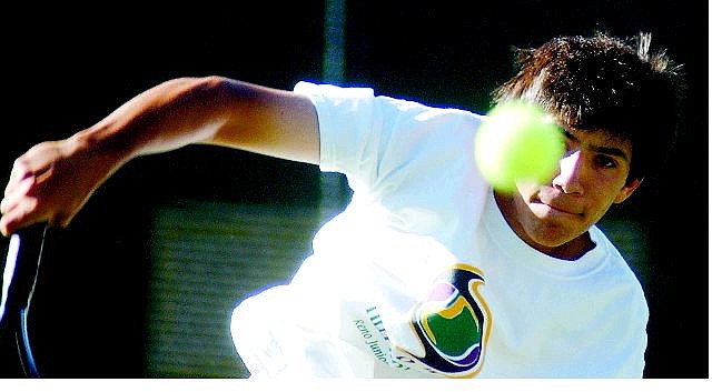 Orion Ashmore returns the ball during his mixed doubles match at the Carson NTRP &amp;Century Tournament on Sunday morning.