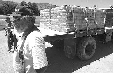 Rick Gunn/Nevada Appeal John Miles of Miles  Brothers Construction Inc. stands with truck driver Gary Gibbons Tuesday near a truckload of cement bound for the C Hill flag project.
