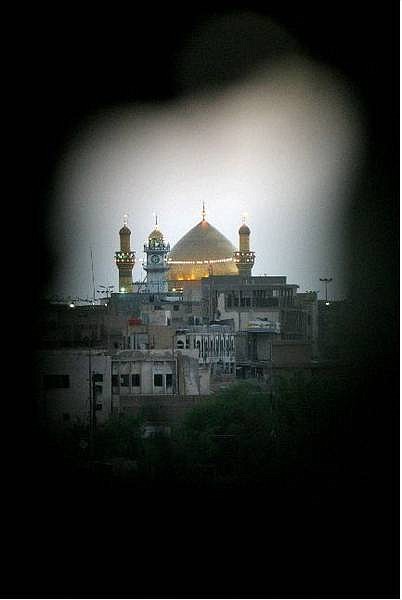 The Shrine of Imam Ali is seen through a hole from a U.S. sniper perch, in Najaf, Iraq, Thursday, Aug. 19, 2004. Later on Friday, militiamen loyal to rebel Shiite cleric Muqtada al-Sadr removed their weapons from the revered Imam Ali Shrine as part of an effort to end 2-week-old uprising centered on the holy site. (AP Photo/Jim MacMillan)