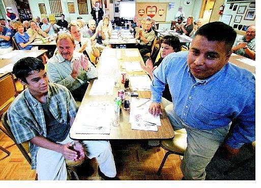 BRAD HORN/Nevada Appeal Ray Guzman receives applause from his son Eric, 13, wife, Margaret, right, among others during the Public Service awards ceremony at the Elks Lodge in Carson City on Saturday.