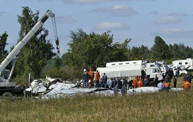 Emergency workers search at the crash site of a Russian Tu-134 near the village of Buchalki in the Tula region, Wednesday, Aug. 25, 2004. Emergency officials said there were 43 people aboard the Tu-134 airliner which crashed in the Tula region, about 200 kilometers (125 miles) south of Moscow. (AP Photo/Misha Japaridze)