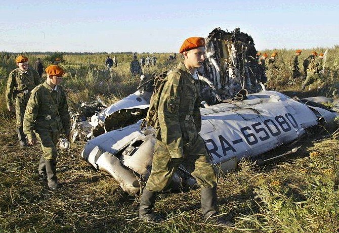 Russian Emergency Ministry soldiers walk near debris of a Russian Tu-134 airliner carrying 43 passengers, which crashed near the village of Buchalki in the Tula region, about 200 kilometers (125 miles) south of Moscow early Wednesday morning, Aug. 25, 2004. The Emergency Situations Ministry said that everybody on board the Tu-134 was killed. (AP Photo/ Misha Japaridze)