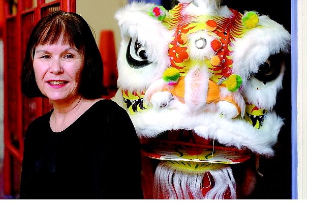 Rick Gunn/Nevada Appeal Dance instructor Carol Oliver sits next to a Chinese lion head in Carson City. She will begin dance classes in Dayton on Sept. 8.