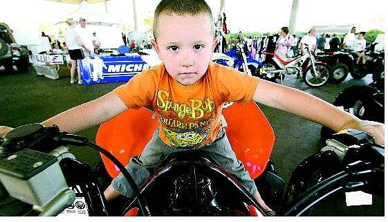 BRAD HORN/Nevada Appeal Anthony Torres, 4, of Carson City sits on a Honda off-road vehicle at the Mills Park Pavillion on Sunday afternoon. Anthony&#039;s grandfather rides quads, and the boy said that when he is old enough, he will join him.