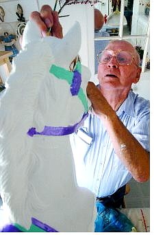 Dyer paints one of his carousel  horses last week at his home.                                  Rick Gunn Nevada Appeal
