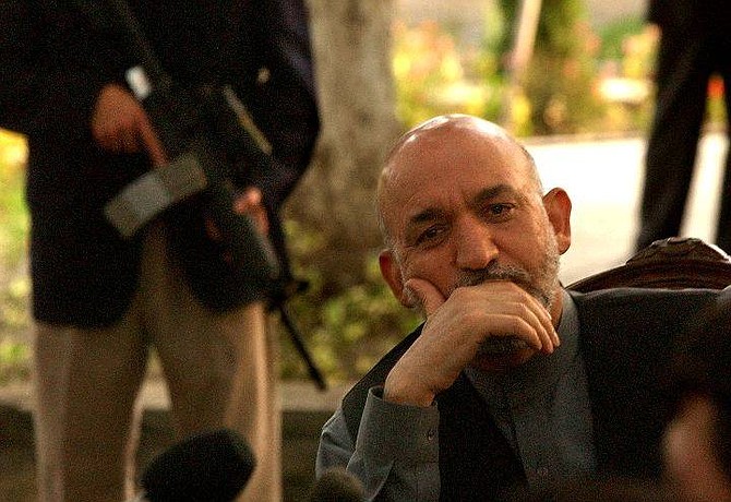 Afghan President Hamid Karzai listens to a reporter&#039;s question during a press conference in Kabul, Afghanistan, Tuesday, Sept. 14, 2004. Karzai escaped a rocket attack on the U.S. helicopter carrying him to a provincial capital in eastern Afghanistan Thursday, Sept. 16, 2004, officials said. No one was hurt. (AP Photo/Emilio Morenatti)