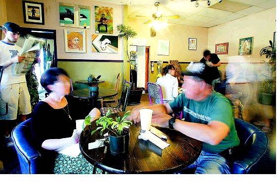 BRAD HORN/Nevada Appeal Susan Mousel, left, and her friend Charles Kihm, of Carson City, sit in Java Joe&#039;s coffee house on Friday afternoon. The local coffee house is filled with various artwork.