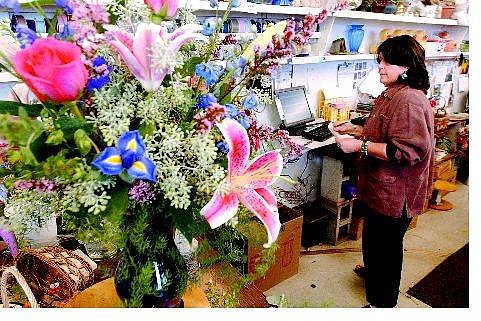 Rick Gunn/Nevada Appeal Juli Grady of Alie&#039;s Flowers finishes up an Internet order Friday. The flower shop recently put itself online to attract those customers who want the convenience of Internet shopping.