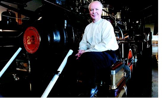 Peter Barton, the new director of the Nevada State Railroad Museum, sits on one of the engines at the museum Friday afternoon.            Rick Gunn Nevada Appeal