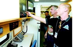 Shannon Litz/Appeal News Service Harry Raub, front, who will train communications staff to use the new Multi-Agency Command Center, shows its features to Douglas County Sheriff&#039;s Office Lt. Mike Biaggini.