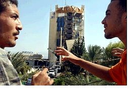 Associated Press Egyptian workers gesture infront of the damaged Hilton Taba, Friday, in Taba, Egypt after Thursday night&#039;s explosion sheared outer rooms off a 10-story wing of the hotel.