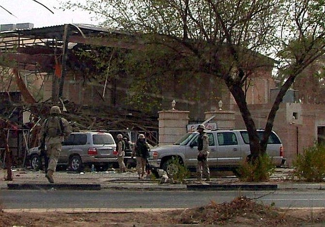 U.S. Army soldiers rush to the scene after &quot;hand-carried &quot; explosives went off at a cafe shop inside the &quot;Green Zone&quot; in Baghdad, Iraq, Thursday, Oct. 14, 2004. Insurgents set off &quot;hand-carried&quot; explosives at a bazaar and cafe in Baghdad&#039;s Green Zone, killing eight civilians and wounding a number of others in the heavily guarded compound that is home to the U.S. Embassy and Iraqi government offices, officials said. (AP Photo/Stuart Francis)