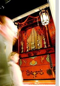 Visitors walk by a historic  Chinese altar at the Nevada State Museum Tuesday afternoon. On Oct. 26, museum curator Bob Nylen will give a  lecture and slide show on some of the more famous exhibits.      Rick Gunn/ Nevada Appeal