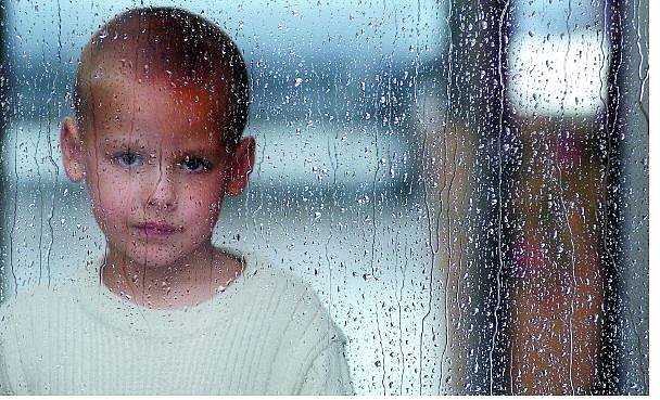 Rick Gunn/Nevada Appeal Austin O&#039;Kelley, 5, stares into the rain out the back door of Cactus Jack&#039;s Tuesday morning. His mother, Karrie, works at the casino and was taking him to school.