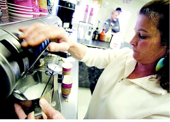 BRAD HORN/Nevada Appeal Kelly Clausson steams milk for a coffee drink at Espresso by F.R. Bean in Dayton on Thursday morning.