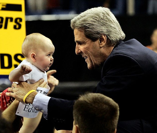 Democratic Presidential candidate Sen. John Kerry, D-Mass.,picks up a baby from the crowd at a rally at the Lawlor Events Center at the University of Nevada in Reno, Nev., Friday, Oct. 22, 2004. (AP Photo/Gerald Herbert)