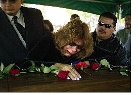 AssociatedPress Gloria Salazar, above, mother of Las Vegas Marine Cpl. William I. Salazar, cries on the coffin of her 26-year-old son Saturday at the Resurrection Cemetery in San Gabriel, Calif. Marine Cpl. William I. Salazar, right, who died Friday, in western Iraq, is shown in Iraq in this undated photo provided by his uncle, Lou Salazar.