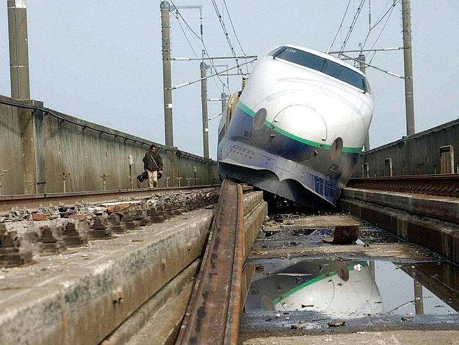 A rear car of the &quot;Toki No. 325&quot; bullet train sits derailed in Nagaoka, northwest of Tokyo, Monday, Oct. 25 2004. For four decades, Japan&#039;s high-speed &quot;bullet&quot;  trains have moved millions of people through this earthquake-prone nation efficiently, at high speed and without a single derailment, until now. The 6.8-magnitude quake that ravaged northern Japan on Saturday knocked the &quot;Toki No. 325&quot; off its tracks,  jarring train officials and prompting a full-scale reassessment of the safety of Japan&#039;s sensitive railway systems. (AP Photo/Katsuya Sato, Pool) ** JAPAN OUT**