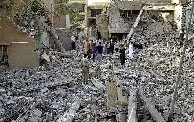 Iraqis inspects a destroyed building in Fallujah, outside Baghdad, Iraq, Tuesday, Oct. 26, 2004, after U.S. troops pounded Fallujah with airstrikes, destroying one house and damaging three others. (AP Photo/Mohammed Khodor)