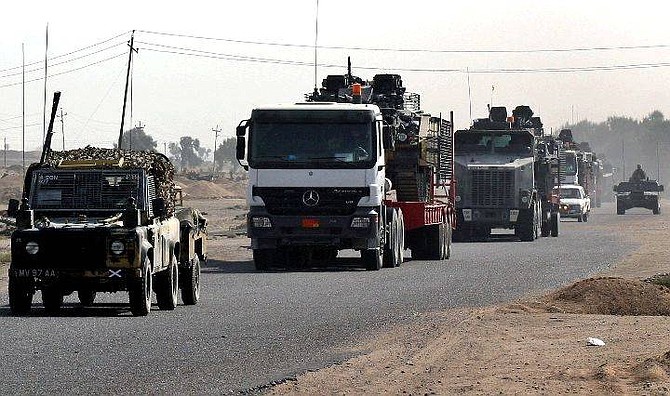 British Army Warrior armoured vehicles of the 1st Battalion, The Black Watch regiment are moved on trucks in a convoy secured by the US Army for redeployment from Basra, Iraq, towards Baghdad Wednesday, Oct. 27, 2004. Nearly 800 British forces left their base in southern Iraq on Wednesday, heading north toward Baghdad to replace U.S. troops who are expected to take part in an offensive against insurgent strongholds. (AP Photo/Nabil Al Jurani)