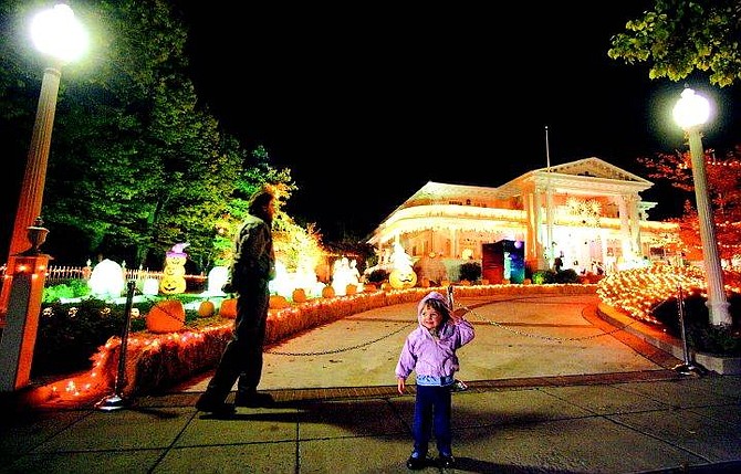 BRAD HORN/Nevada Appeal Lauren Winnie, 3, of Carson City, checks out Nevada Gov. Kenny Guinn&#039;s Halloween decorations at the Governor&#039;s Mansion on Thursday evening with her father Don. The Governor&#039;s Mansion is one of many in Carson City that are supposedly haunted.