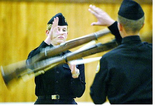 Cathleen Allison/Nevada Appeal Carson High School Naval Junior ROTC Cadet 3rd Platoon Cmdr. Megan Hanke performs with the Armed Drill Team during Wednesday&#039;s annual military inspection Wednesday.