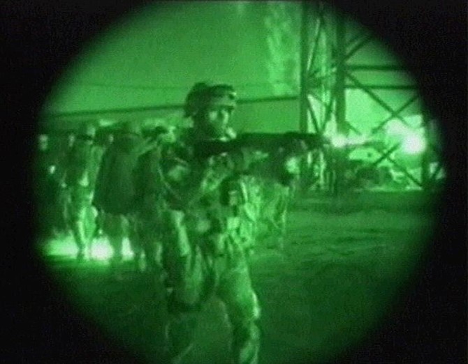 A nightscope image made from TV of US and Iraqi soldiers outside Fallujah hospital, Iraq, Monday, Nov. 8, 2004. US forces stormed into western districts of Fallujah early on Monday, seizing the main city hospital and securing two key bridges over the Euphrates River in what appeared to be the first stage of the long-expected assault on the rebel stronghold. (AP Photo / APTN / Pool)