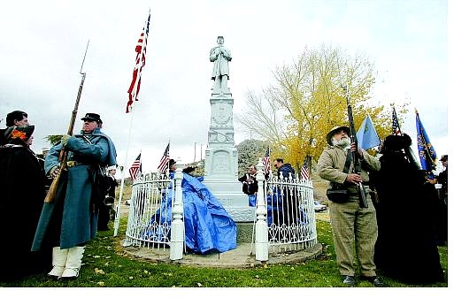 BRAD HORN/Nevada Appeal Thomas Lynch, from left, and Larry Steinberg stand guard at the site of the Civil War statue during its dedication at the Lone Mountain Cemetery in Carson City on Thursday.