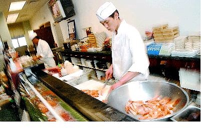 Rick Gunn/Nevada Appeal Chen Wei preps shrimp at the sushi bar at Ming&#039;s Restaurant Friday.