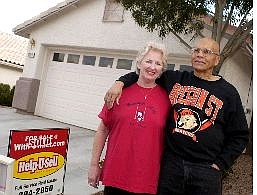 Isaac Brekken/Las Vegas Review Journal Geno and Kathy Brown stand in front of their former home Oct. 22, 2004, in Las Vegas. They bought the two-bedroom home eight years ago in the Summerlin section of Las Vegas for $105,000. They recently sold it for $250,000 in a matter of hours. The Browns are moving to Salem, Ore., where they&#039;re buying a new three-bedroom home for $153,000.