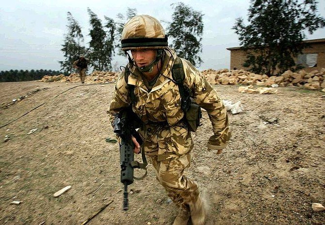 British soldiers of Delta company from the Black Watch regiment run for cover after a mortar round exploded near their position at the bank of the Euphrates river 25 miles south of Baghdad, Iraq  Wednesday Nov. 17, 2004. About 850 British troops, mainly from the Black Watch, are deploying in a restive region just south of Baghdad, allowing U.S. troops to reinforce units fighting insurgents in the Sunni Muslim city of Fallujah . (AP Photo/Damir Sagolj, Pool)