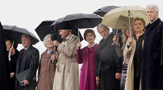 Former First Lady Rosalynn Carter, left to right, former President Jimmy Carter, former First Lady Barbara Bush, former President George H. W. Bush, First Lady Laura Bush, President George W. Bush, Chelsea Clinton, Sen. Hillary Rodham Clinton and former  President Bill Clinton, watch from under umbrellas at the William J. Clinton Presidential Center during opening ceremonies in Little Rock, Ark., Thursday, Nov. 18, 2004.   The $165 million glass-and-steel center will be the home to  Clinton&#039;s library collection of more than 80 million presidential items.  (AP Photo/Pablo Martinez Monsivais)