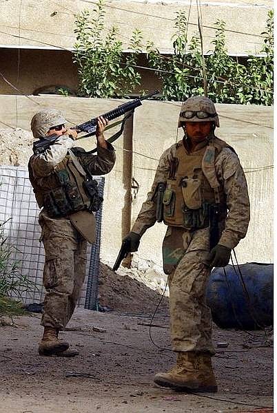 US soldiers patrol in Fallujah, Iraq,  Friday Nov. 26 2004.  In Fallujah, insurgents ambushed U.S. troops as they entered a home during house-to-house searches in the former rebel bastion, killing two Marines and wounding three others, the U.S. military said Friday. (AP Photo/Hadi Mizban)