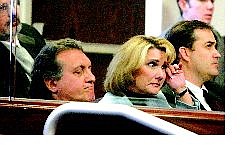 State Controller Kathy Augustine, center, wipes away a tear in the Senate Chambers during impeachment proceedings while her attorneys Dominic Gentile, left, and John Arrascada listen Saturday in Carson City.  Brad Horn Nevada Appeal