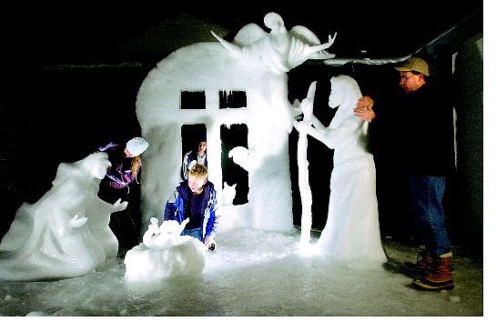 Rick Gunn/Nevada Appeal The Hagan family smooths out the finish on a frozen Nativity scene Monday evening after they spent 60 hours crafting it out of snow. They are from left, Shelby, 12; Tyler, 9; Jared, 8, and dad Pete Hagan. You can view the scene at 1693 Kingsley Ave.