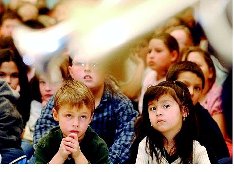 Rick Gunn/Nevada Appeal Bordewich-Bray Elementary School kindergartners Sawyer Barnett, and Edith Hernandez, both 5, listen to the Great Basin Brass on Tuesday morning in the auditorium. The quintet performed at the school as part of the Discover Music, outreach program.