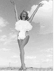 Who is the woman in this 1957 photo, provided by the Las Vegas News Bureau? Friedrichs hopes to identify and credit the young, high-heeled woman attired mostly in a frothy cotton mushroom cloud, who may be the most famous pop-culture image of the above-ground nuclear explosions at the Nevada Test Site.