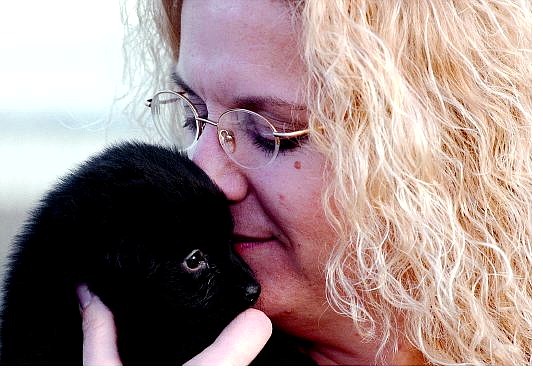 Dr. Lesli Hewitt, DVM, nuzzles tiny Dexter at Sierra Veterinary  Hospital on Tuesday. Hewitt, technician assistant Andrea Mundt and a group of firefighters saved the puppy&#039;s life after crews  responded to a call of a  choking baby.                                 Rick Gunn Nevada Appeal