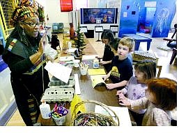 Cathleen Allison/Nevada Appeal Isha Echols, left, talks to a group of children at the Nevada Children&#039;s Museum Monday afternoon as part of a seven-day Kwanzaa festival.  Echols told stories, sang and made crafts with the children.