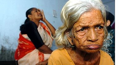 Kunjumol, 90, right, a tsunami victim, sits at a relief center at Chellanam, in the southern Indian state of Kerala Wednesday. More than 77,000 people are reported dead around southern Asia and as far away as Somalia on Africa&#039;s  eastern coast, most killed by massive tidal waves after a magnitude-9.0 earthquake off Indonesia&#039;s coast on Sunday. Associated Press