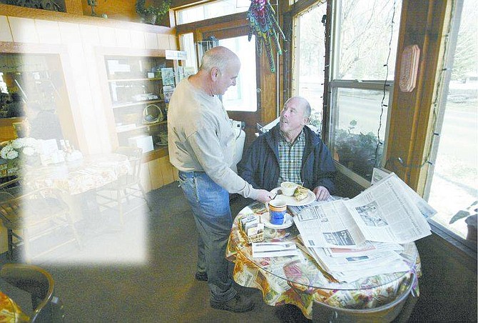 Cathleen Allison/Nevada AppealMom &amp; Pop&#039;s Diner owner Doug Cramer, left, waits on customer Jim Spencer Thursday at his downtown Carson City restaurant. Local business owners are looking forward to the increased business that comes with the Legislative session.
