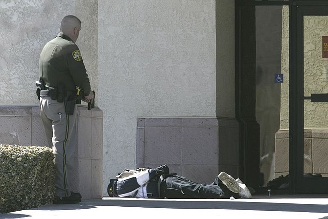 Cathleen Allison/Nevada AppealA man with a suspected bomb is held at bay by a Carson City Sheriff&#039;s Deputy.