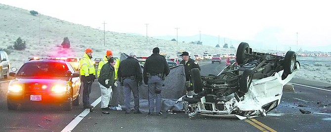 BRAD HORN/Nevada AppealNevada Highway Patrol troopers, a Carson City coroner, and Department of Transportation employees work the scene of a fatal accident that claimed the life of two men this morning on Highway 50.