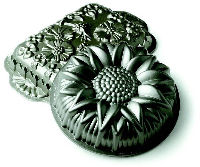 The Bundt pan isn&#039;t just another pretty face among baking dishes. The carefully constructed design conducts heat to the center of the cake, which would otherwise brown on the outside before the inside is cooked through. Here, two of Nordic Ware&#039;s floral design pans. Illustrates BUNDT (category d), by Bonnie S. Benwick (c) 2005, The Washington Post. Moved Tuesday, Jan. 11, 2005. (MUST CREDIT: Washington Post photo by Julia Ewan.)