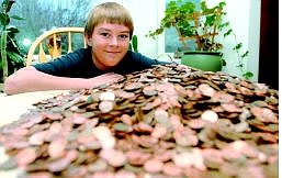 Shannon Litz/Appeal News Service Will Lockett, 11, with pennies he cashed in at the Carson Valley Inn to help with tsunami relief efforts. The pennies amounted to $175.32.