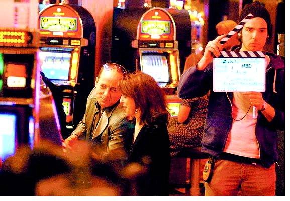 BRAD HORN/Nevada Appeal Angelo Fierro, left, playing the part of Louis Colavecchio, talks to co-star Julie Anchor, as his girlfriend, Donna Ulrich, while production assistant Ross Levine signals to the camermen at the Carson Nugget Thursday night.